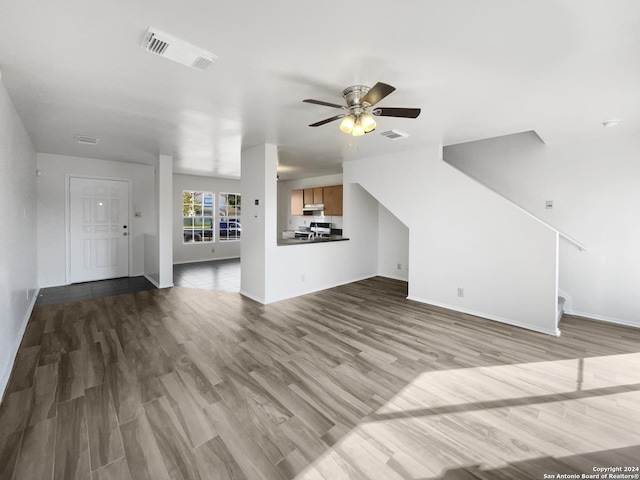 unfurnished living room with light hardwood / wood-style flooring and ceiling fan