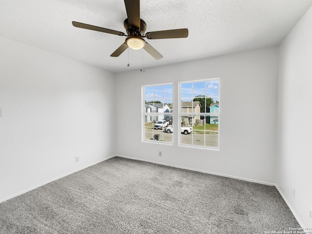 spare room with ceiling fan, carpet, and a textured ceiling