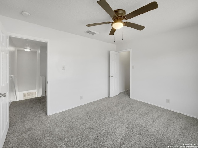 unfurnished room with carpet flooring and ceiling fan