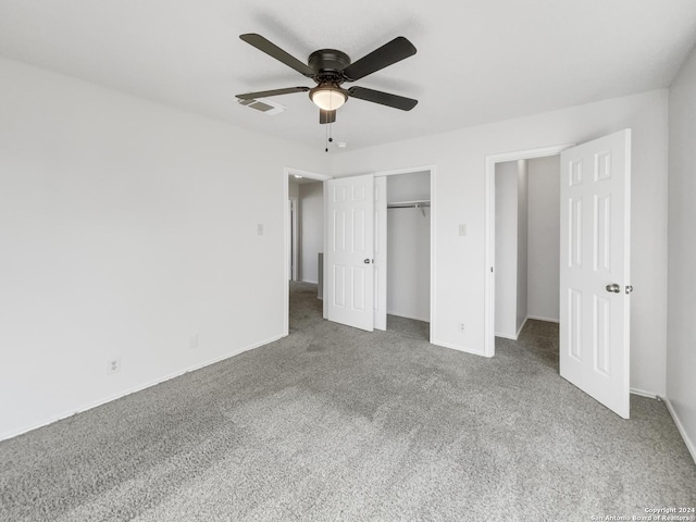 unfurnished bedroom featuring carpet, ceiling fan, and a closet