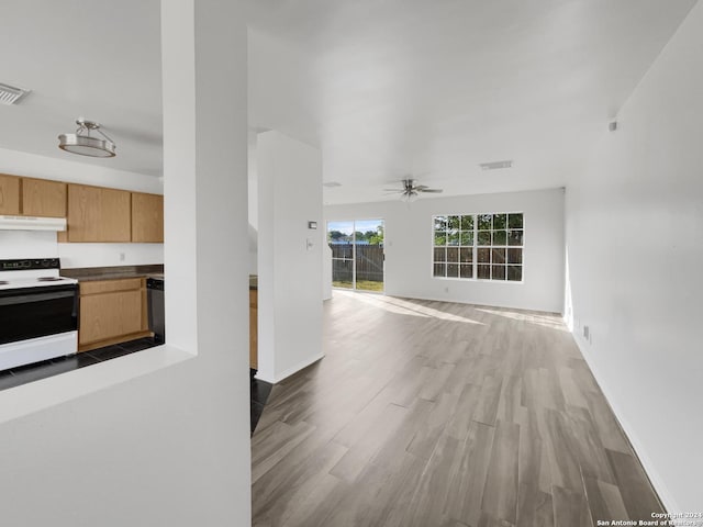 interior space with light hardwood / wood-style floors, white range with electric cooktop, ceiling fan, and stainless steel dishwasher