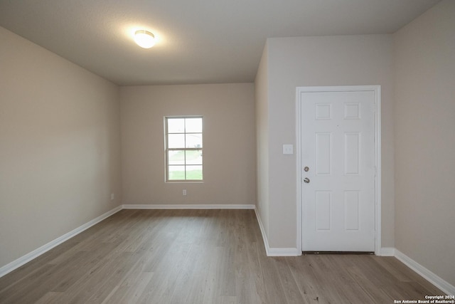 unfurnished room with light wood-type flooring