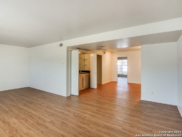 unfurnished living room with hardwood / wood-style flooring