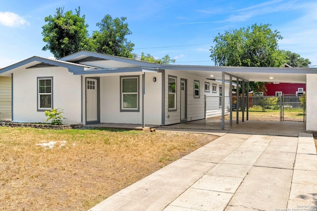 ranch-style home featuring a carport and a front yard