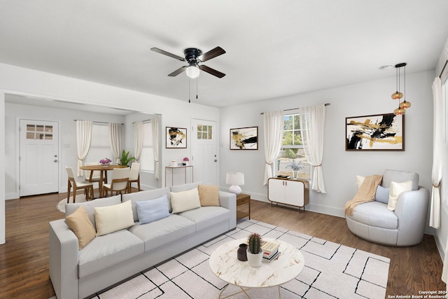 living room featuring wood-type flooring and ceiling fan