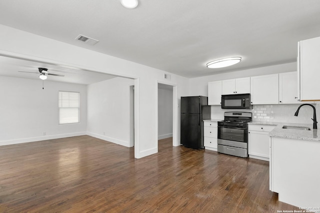 kitchen with white cabinetry, sink, light stone counters, decorative backsplash, and black appliances