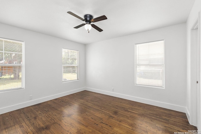 spare room featuring ceiling fan and dark hardwood / wood-style flooring