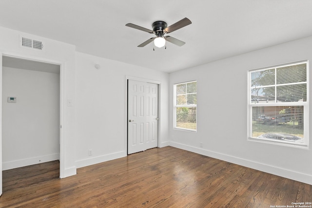 unfurnished room with ceiling fan and dark hardwood / wood-style floors