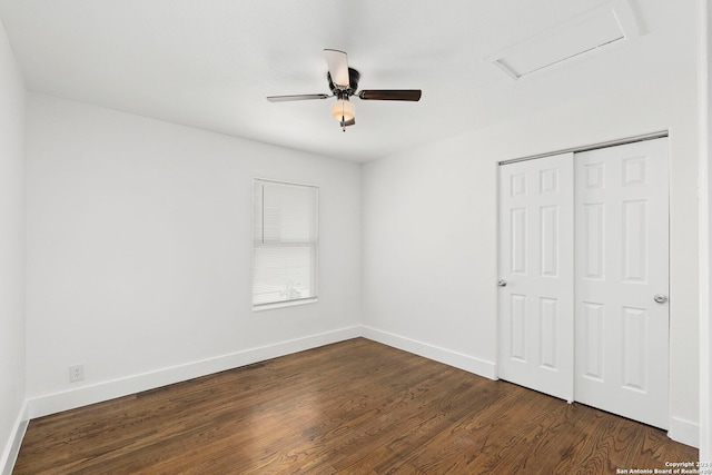 unfurnished bedroom with ceiling fan, dark hardwood / wood-style flooring, and a closet