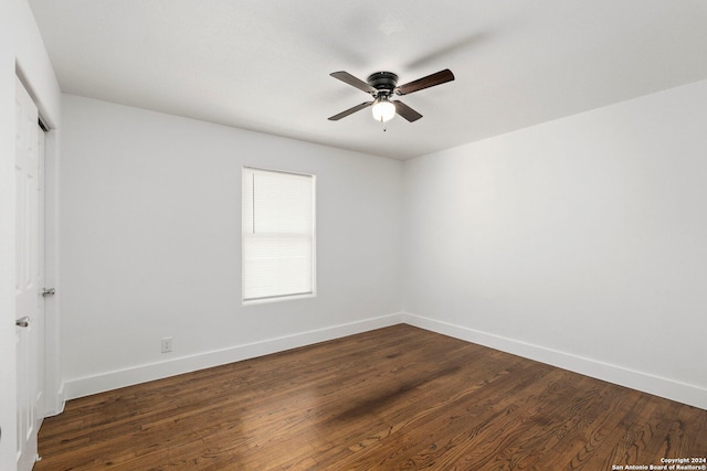 spare room with ceiling fan and dark hardwood / wood-style flooring