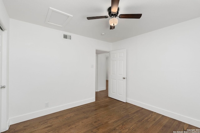 unfurnished bedroom with ceiling fan and dark hardwood / wood-style flooring