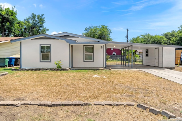 ranch-style house with a front lawn and a carport