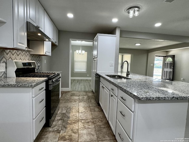 kitchen with white cabinets, tasteful backsplash, sink, and gas range