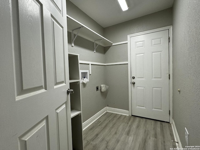 spacious closet featuring light hardwood / wood-style floors