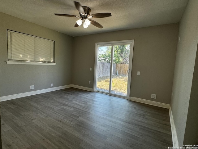 unfurnished room with a textured ceiling, dark hardwood / wood-style flooring, and ceiling fan