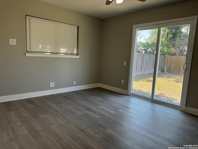 empty room featuring ceiling fan and dark wood-type flooring