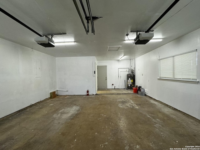 garage featuring water heater and a garage door opener