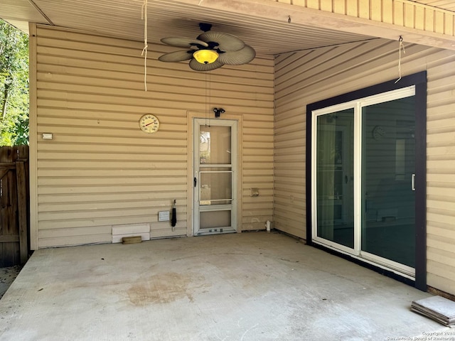 entrance to property featuring ceiling fan and a patio