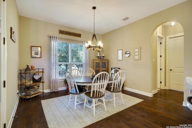 dining room featuring dark hardwood / wood-style flooring and a notable chandelier