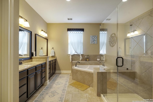 bathroom featuring tile patterned floors, a wealth of natural light, vanity, and plus walk in shower