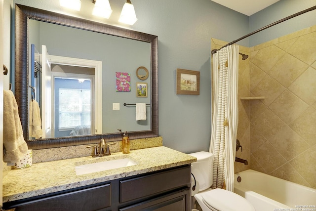 full bathroom with vanity, shower / tub combo, and toilet