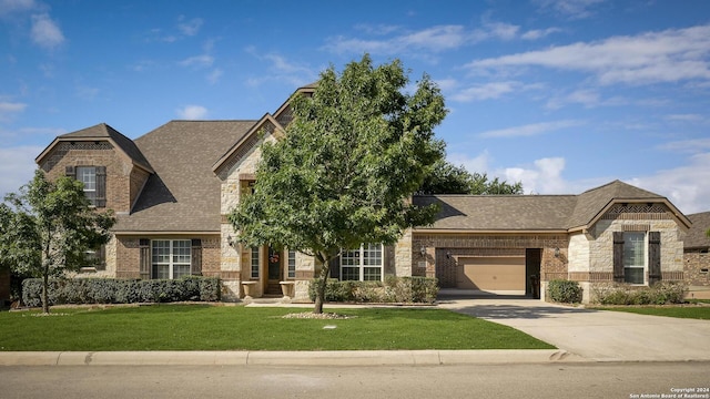 view of front facade with a garage and a front lawn