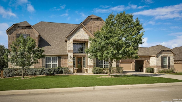 view of front facade with a garage and a front lawn