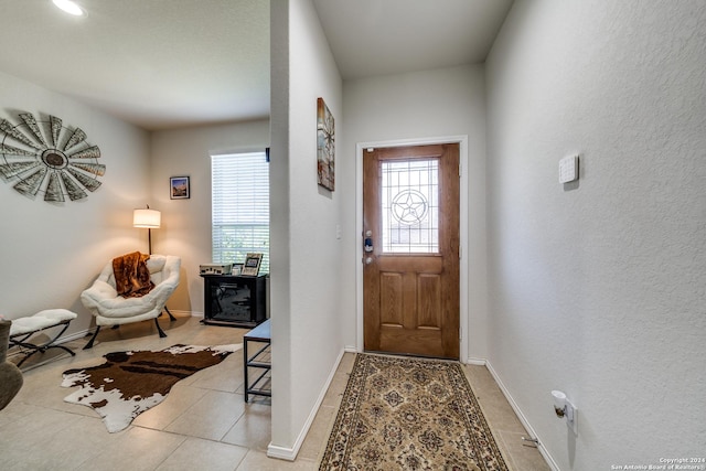 entryway with light tile patterned flooring