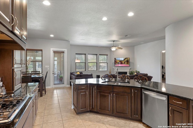 kitchen featuring dark brown cabinetry, ceiling fan, sink, light tile patterned flooring, and appliances with stainless steel finishes