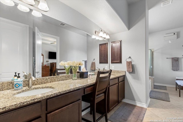 bathroom with tile patterned flooring, vanity, and an enclosed shower