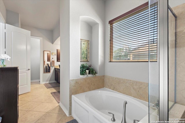 bathroom with tile patterned floors, vanity, and separate shower and tub