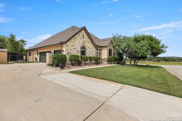 view of front of home featuring a garage and a front lawn