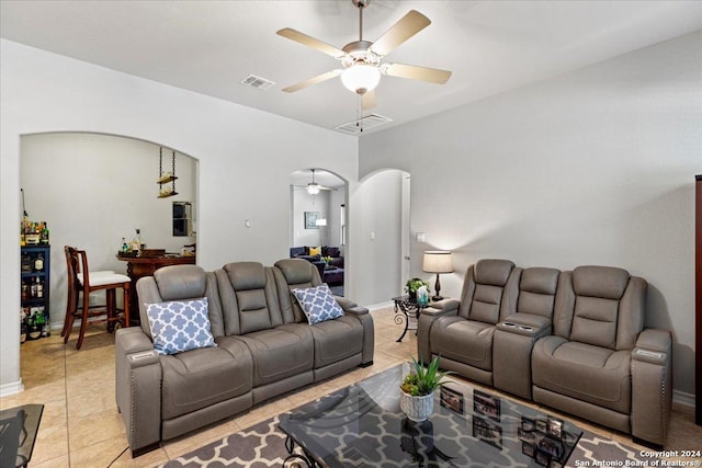 tiled living room with ceiling fan