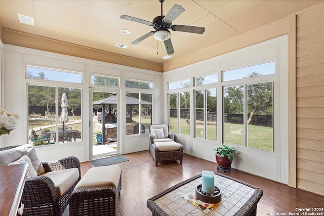 sunroom with ceiling fan and a healthy amount of sunlight