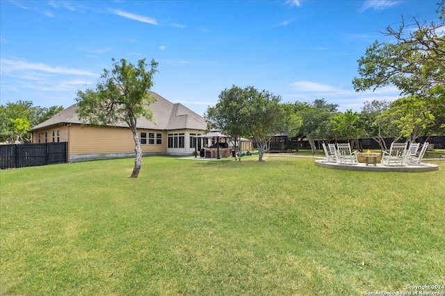 view of yard with a patio area and an outdoor fire pit