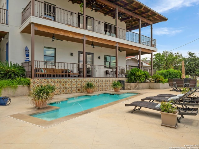 view of swimming pool with a patio area, ceiling fan, and pool water feature