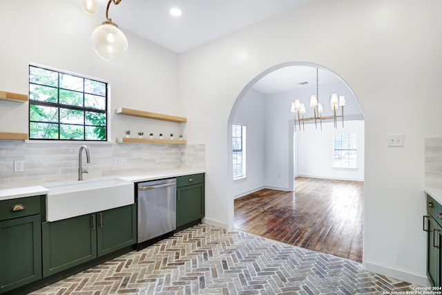 kitchen featuring a healthy amount of sunlight, hardwood / wood-style flooring, tasteful backsplash, stainless steel dishwasher, and sink