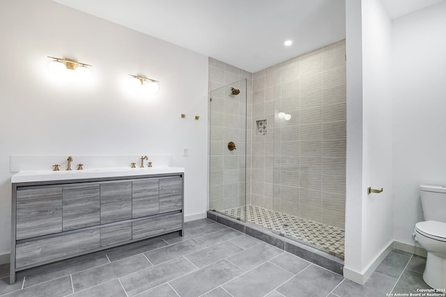 bathroom with tile floors, walk in shower, vanity, and toilet