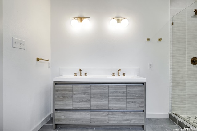 bathroom featuring a shower with door, tile flooring, and dual vanity