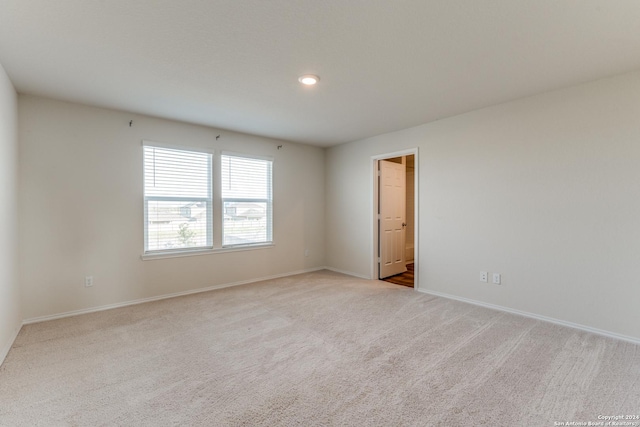 empty room featuring light colored carpet