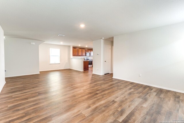 unfurnished living room with hardwood / wood-style floors