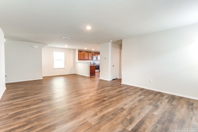 unfurnished living room featuring dark wood-type flooring