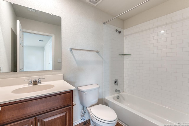 full bathroom featuring tiled shower / bath combo, vanity, and toilet