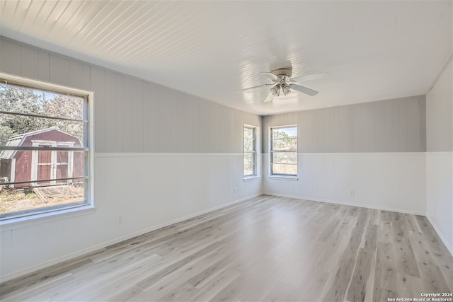 unfurnished room with ceiling fan and light hardwood / wood-style floors