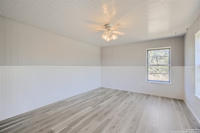 spare room with ceiling fan and light wood-type flooring