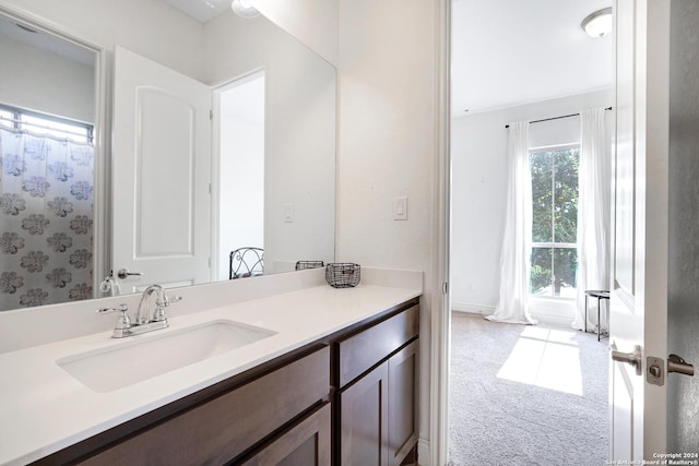 bathroom with a shower with shower curtain and vanity