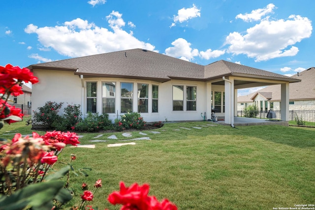 rear view of house with a lawn and a patio area