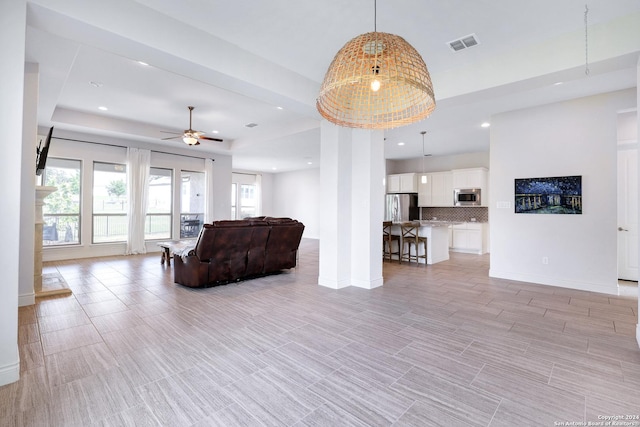 unfurnished living room with ceiling fan