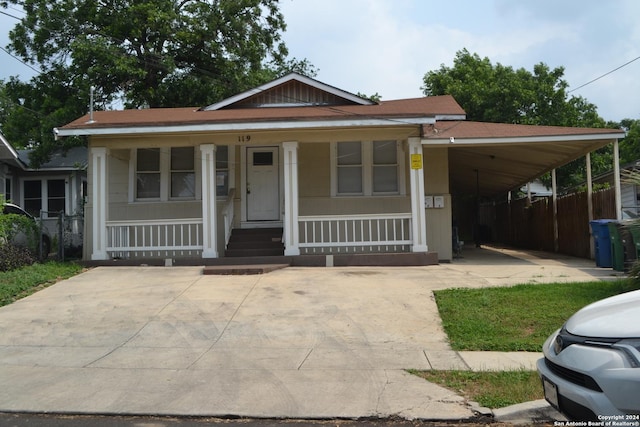 view of front of property featuring covered porch and a carport