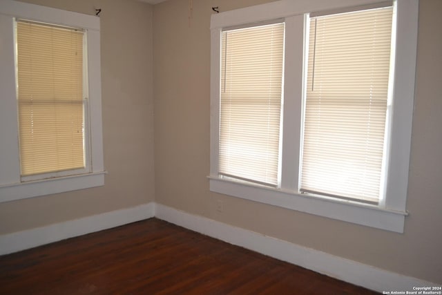 empty room with dark hardwood / wood-style floors